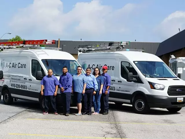A‑C Air Care HVAC service team standing in front of branded service vans professional heating and air conditioning technicians