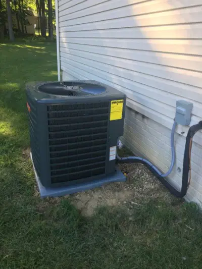 AC repair Elkridge MD outdoor air conditioning unit being serviced by HVAC technician residential cooling service