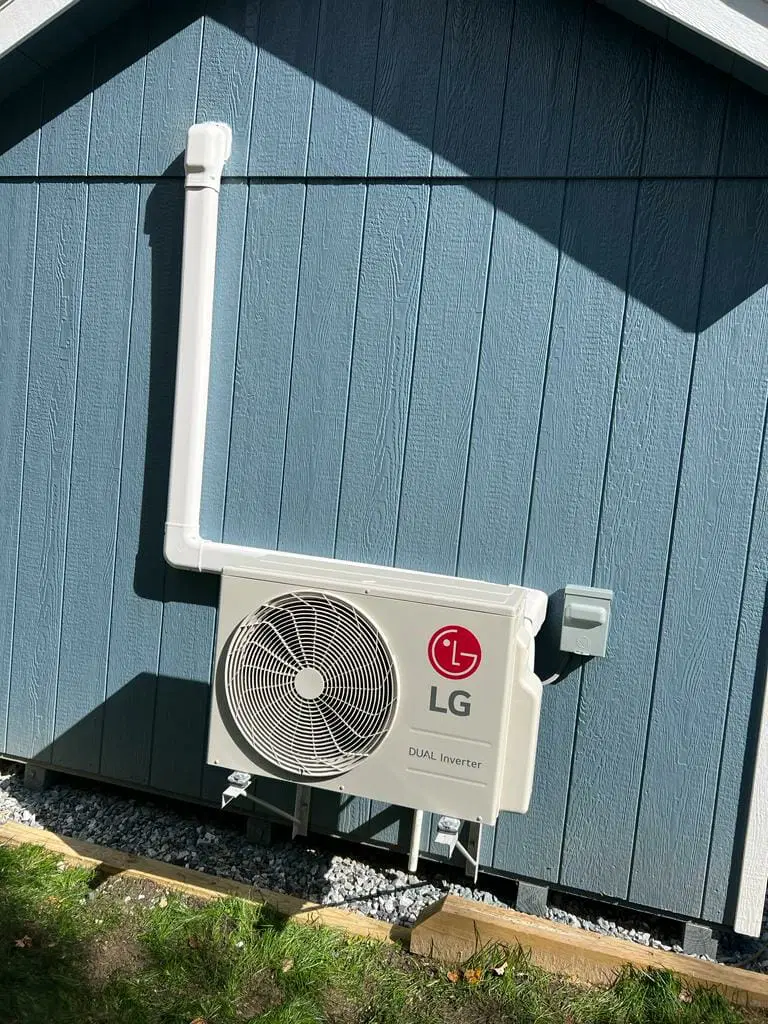 ductless mini split air conditioning unit installed on exterior wall residential HVAC cooling system